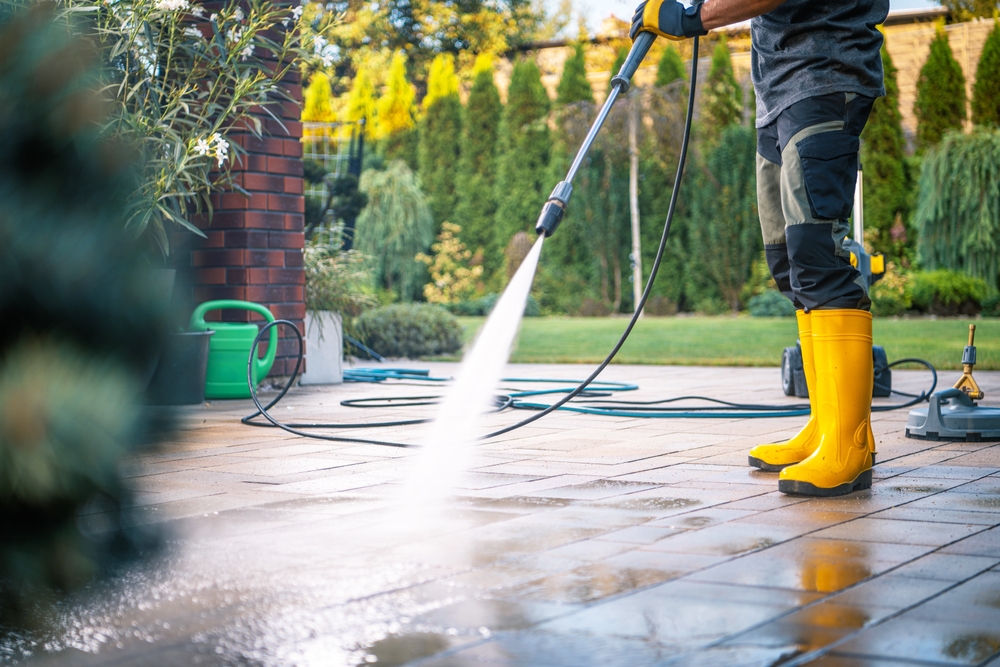 A,Person,Wearing,Yellow,Boots,Operates,A,Pressure,Washer,On
